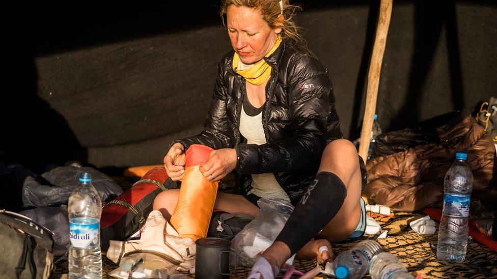 Sophie Raworth taping her feet before stage four of the Marathon des Sables