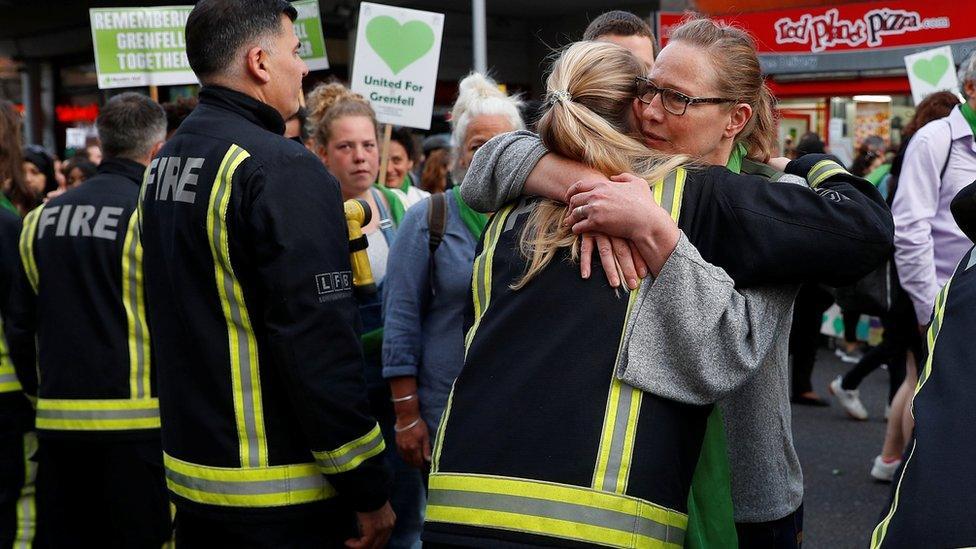 Woman and firefighter hug