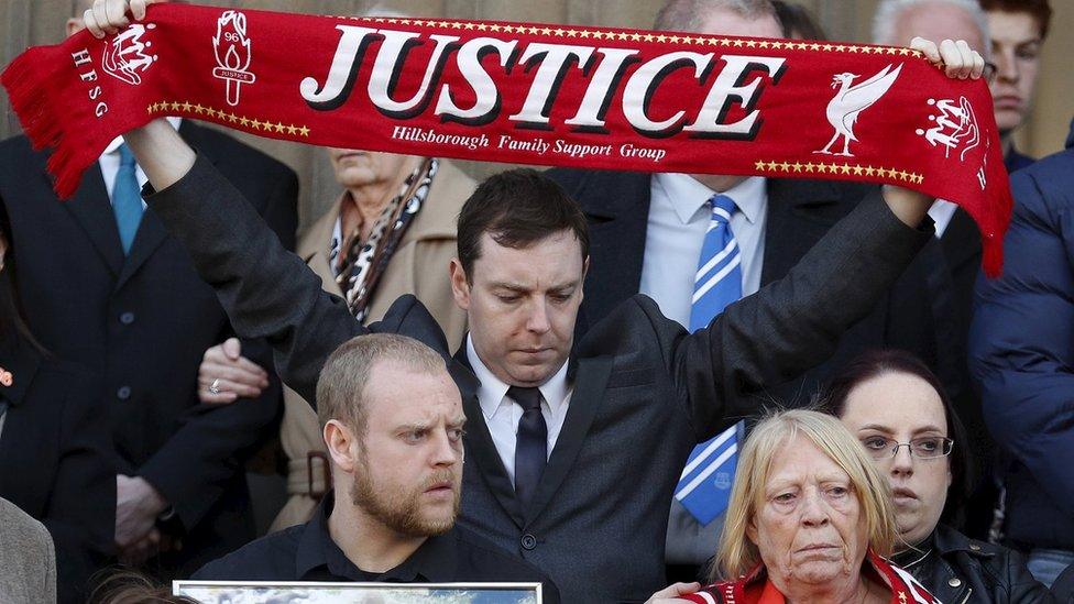 A Hillsborough family campaigner holding up a justice scarf