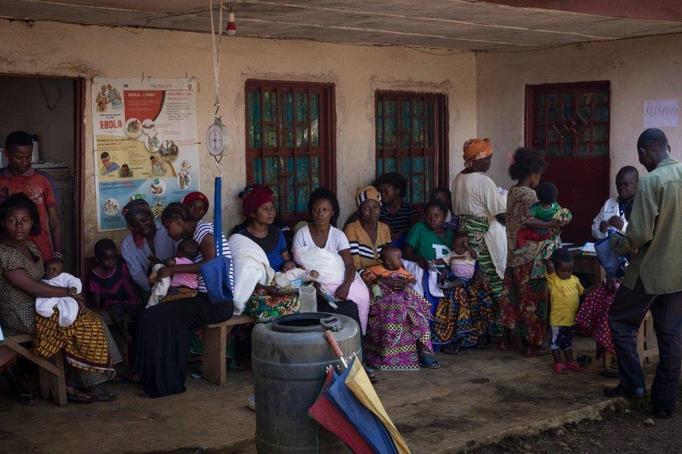 Parents queues with their children outside Iganda health centre