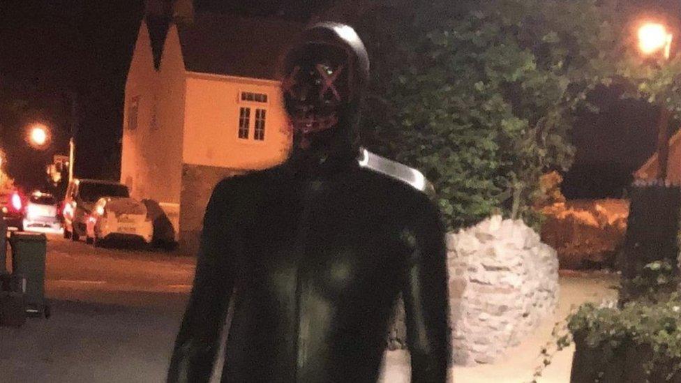 Man in gimp outfit