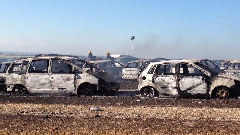 Burnt-out vehicles at Boomtown