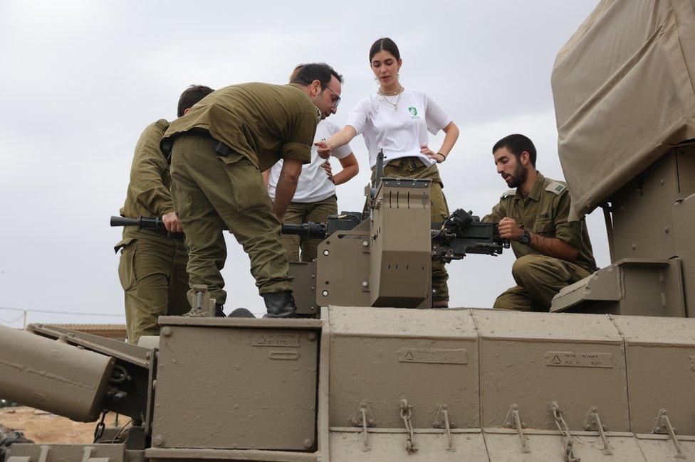 Army reservists stand near Beer Sheva, Israel on Sunday. About 360,000 have been called up.