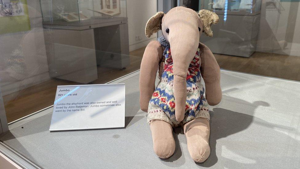 stuffed toy elephant wearing multicoloured dress