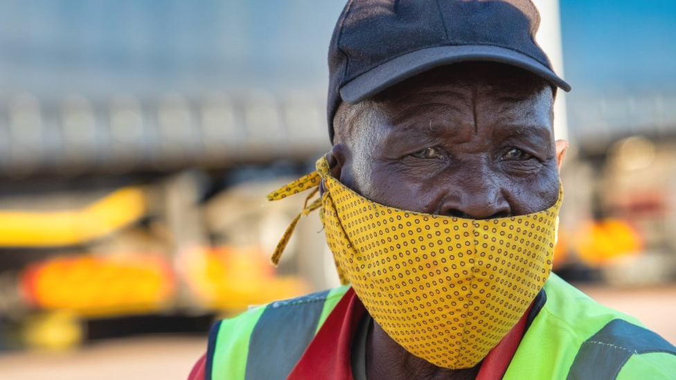 Man wearing yellow mask