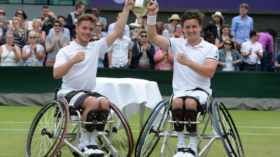 Gordon and his partner Alfie Hewett lift the trophy for the men's wheelchair doubles at Wimbledon