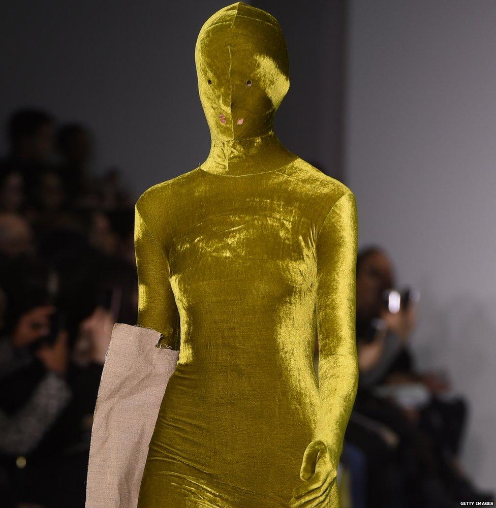 A model totally covered in gold cloth at London fashion week