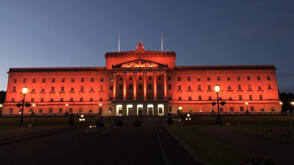 Parliament Buildings in Stormont lit up in orange to mark the Twelfth of July 2021