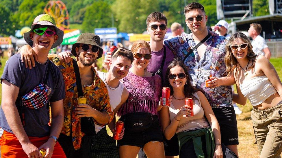 A group of young men and women smile for the camera at Ashton Court