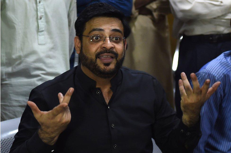 In this picture taken on July 11, 2018, Aamir Liaquat Hussain, a televangelist and an election candidate of the political party Pakistan Tehreek-e-Insaf (Movement for Justice) of Imran Khan, gestures as he speaks with students during an election campaign in Karachi.