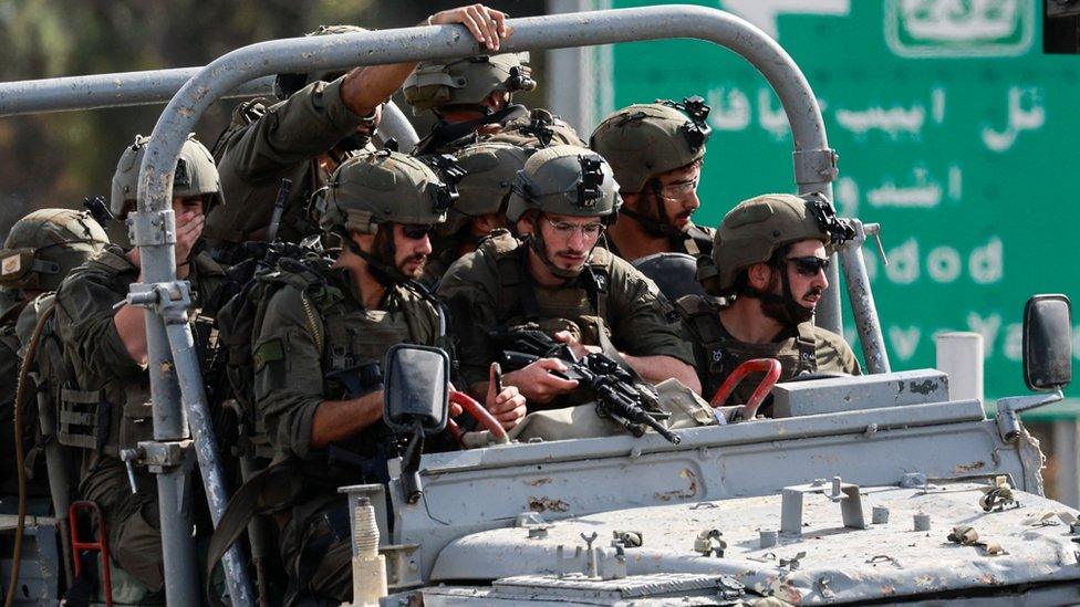 Israeli military drive on a road in southern Israel, as rockets are launched from the Gaza Strip, outside Sderot October 7, 2023