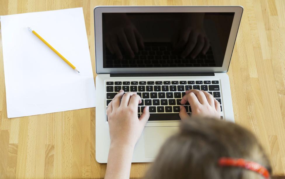 Schoolgirl using laptop