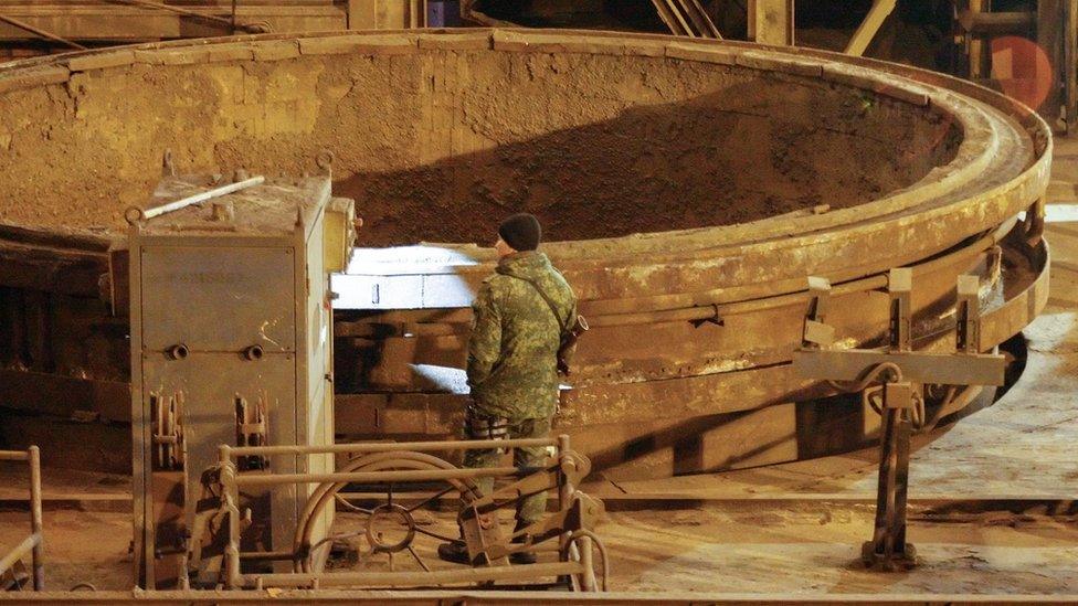 Pro-Russian rebel stands guard at Uzov metallurgy works in Donetsk - 1 March