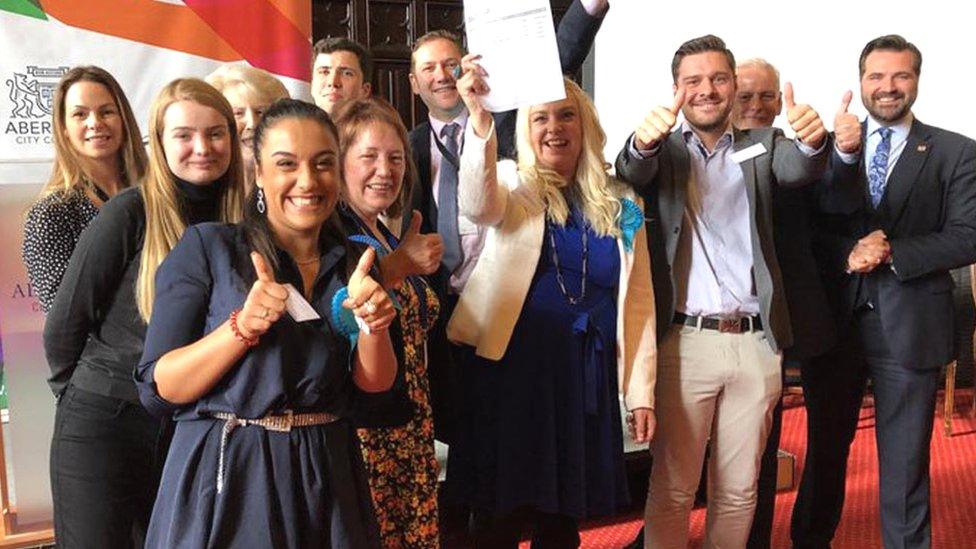 Sarah Cross (centre with paper) celebrates