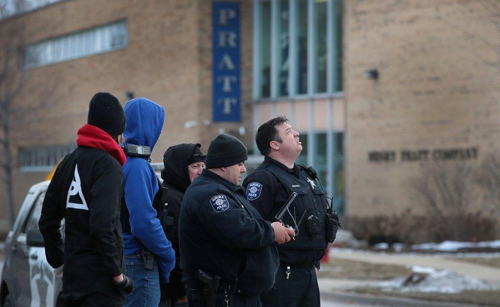 Police secure the area following a shooting at the Henry Pratt Company in Aurora, Illinois, 15 February 2019