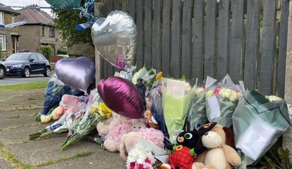 Balloons left in tribute to the family killed in the house fire