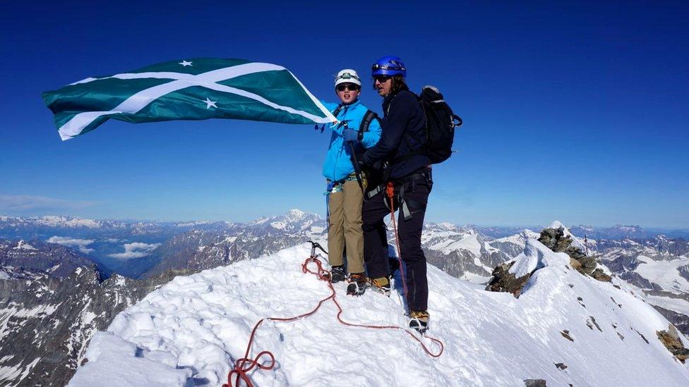 Jules made it to the top of the Matterhorn and brought his school flag