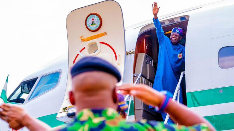 Nigeria's President Bola Tinubu waving from a presidential jet