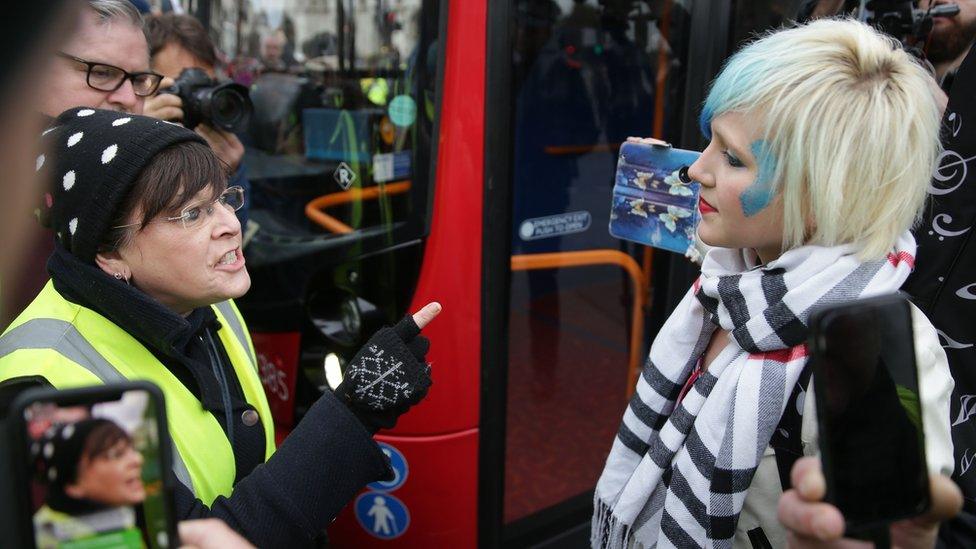 A Pro-Brexit protester argues with a woman holding opposing views in Parliament square during a demonstration in central London