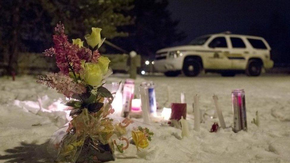 Candles and flowers placed as a memorial lay near the La Loche, Saskatchewan, junior and senior high school