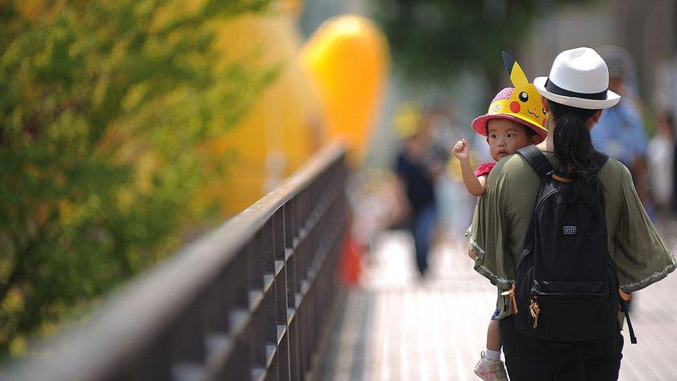 A mother carrying her baby in Japan