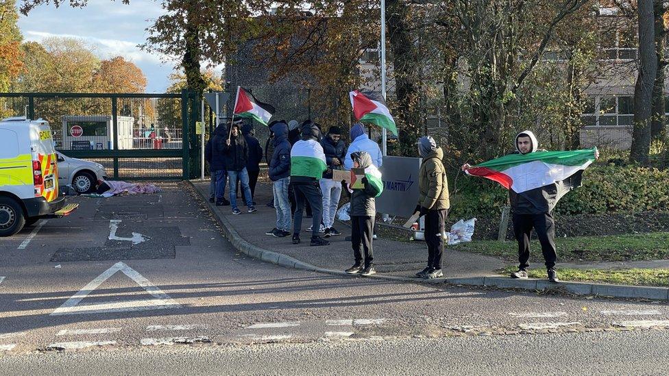 Protestors outside Lockheed Martin with Palestine flags