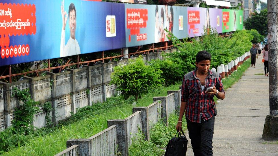 Billboards by Yangon road advertising Qatari based Ooredoo telecoms service