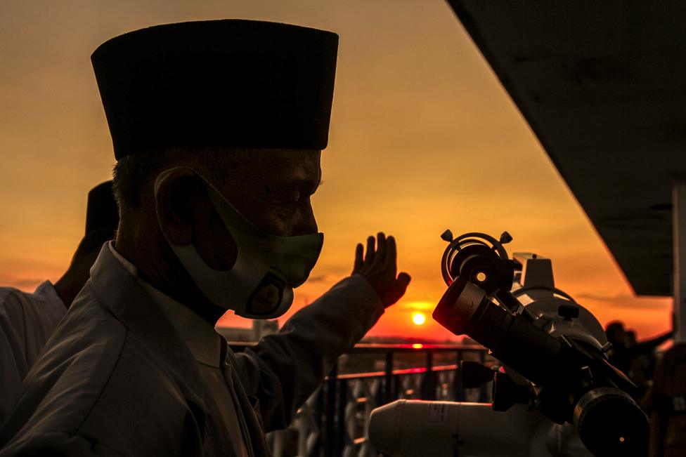 Muslims use a telescope as the sun sets