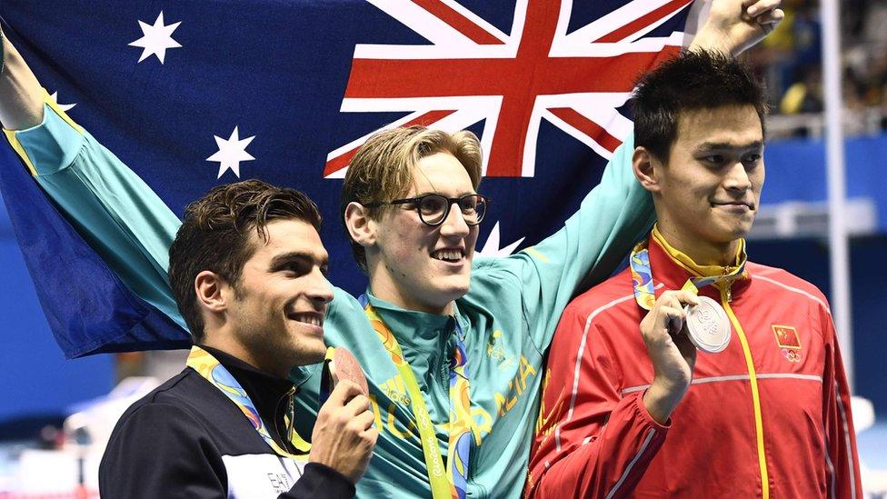 Gold medallist Mack Horton on the podium with silver medallist Sun Yang and bronze medallist Grabriele Detti, of Italy after the Men's 400m Freestyle Final