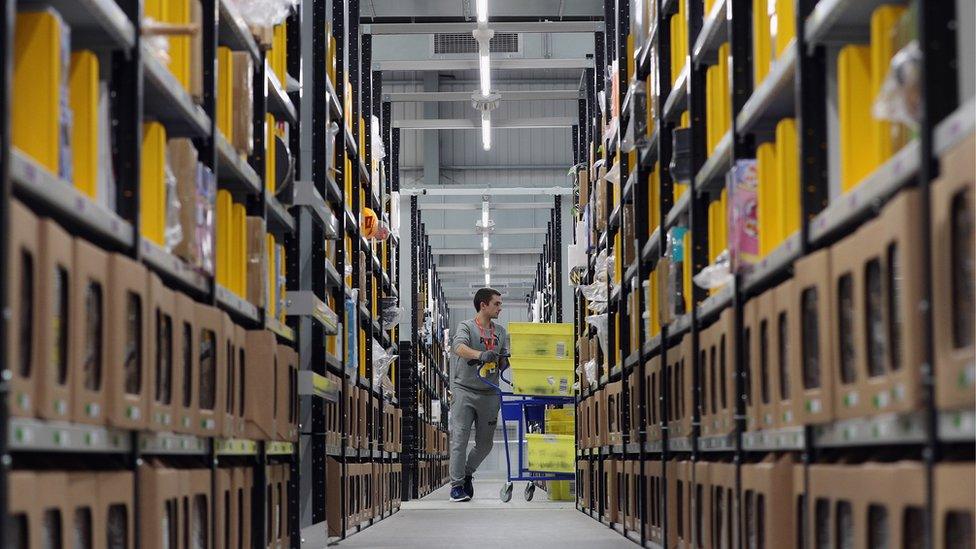 Parcels are processed and prepared for dispatch at Amazon's fulfillment centre in Peterborough, England