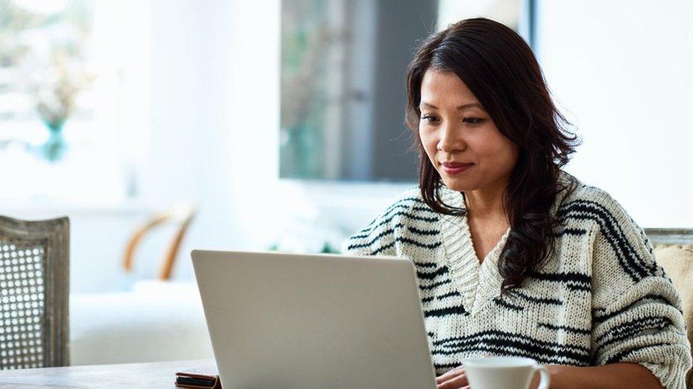 A woman working at her laptop