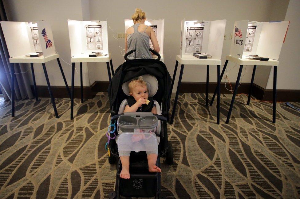 Lucille Lemkin waits in her stroller as her mother casts her ballot at the Luxe Hotel, California