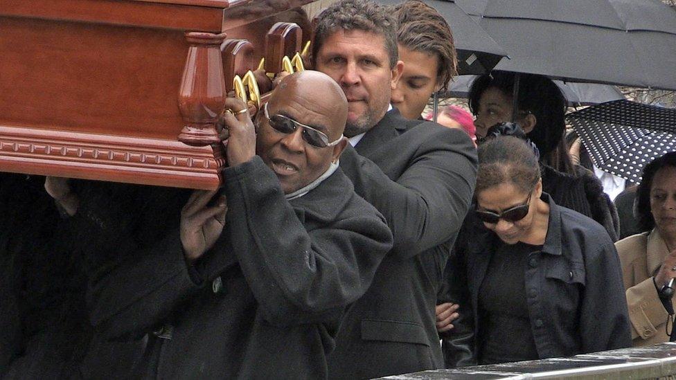 Chris Amoo carries in the coffin