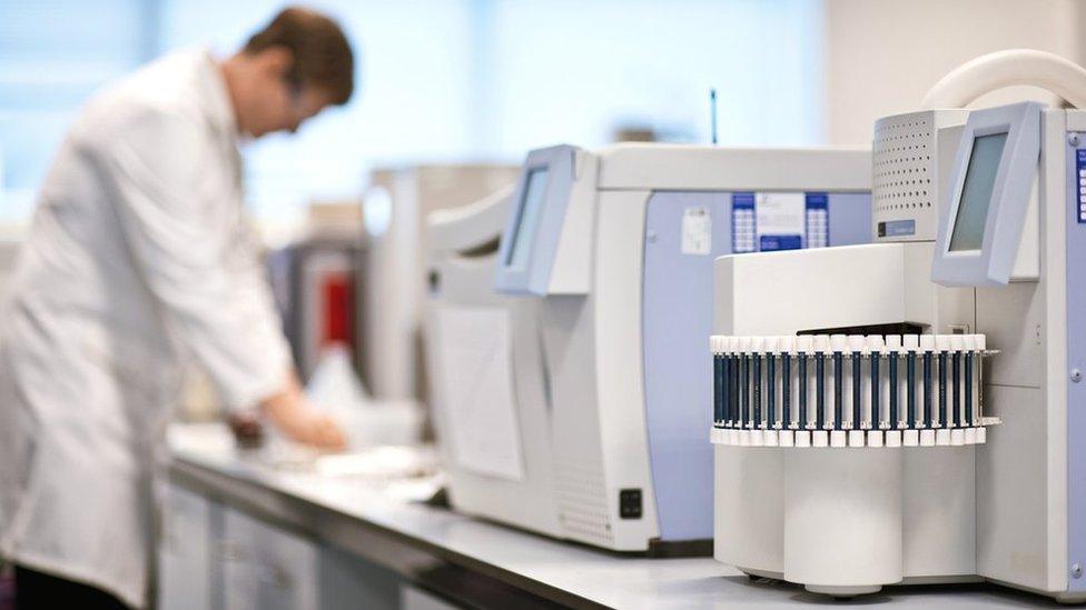 chemistry researcher using machines in a laboratory