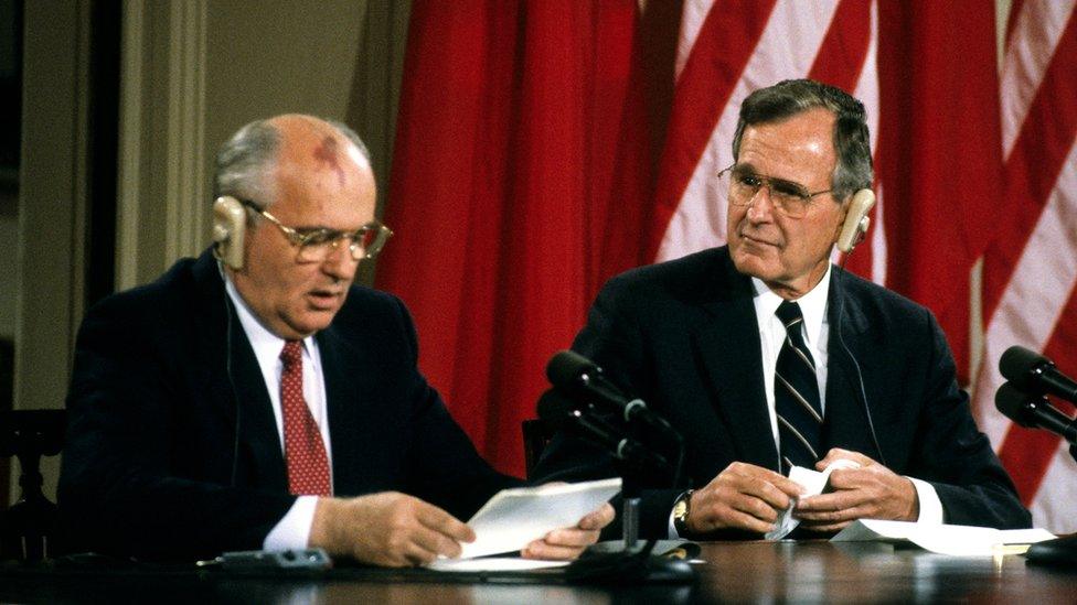 Soviet President Mikhail Gorbachev (left) and US President George HW Bush hold a joint press conference in the White House's East Room, Washington DC, June 3, 1990. (Photo by Ron Sachs