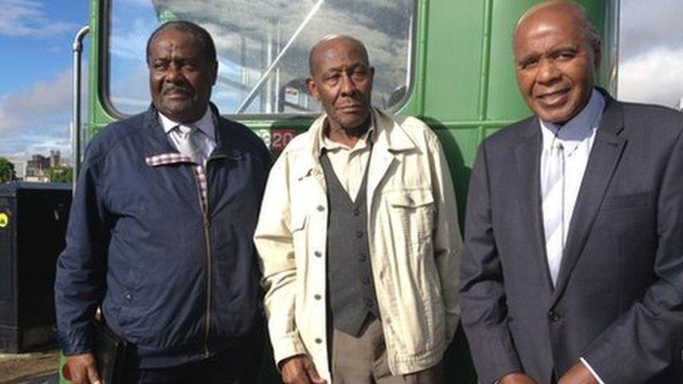 Guy Bailey, Roy Hackett and Paul Stephenson in front of one of the original green buses - modern photo