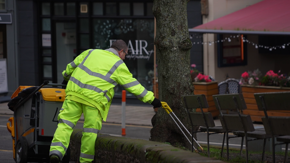 Bin man cleaning up area