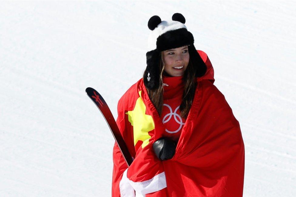 Gold medallist Ailing Eileen Gu of Team China reacts during the Women's Freeski Halfpipe flower ceremony on Day 14 of the Beijing 2022 Winter Olympics at Genting Snow Park on February 18, 2022 in Zhangjiakou, China.