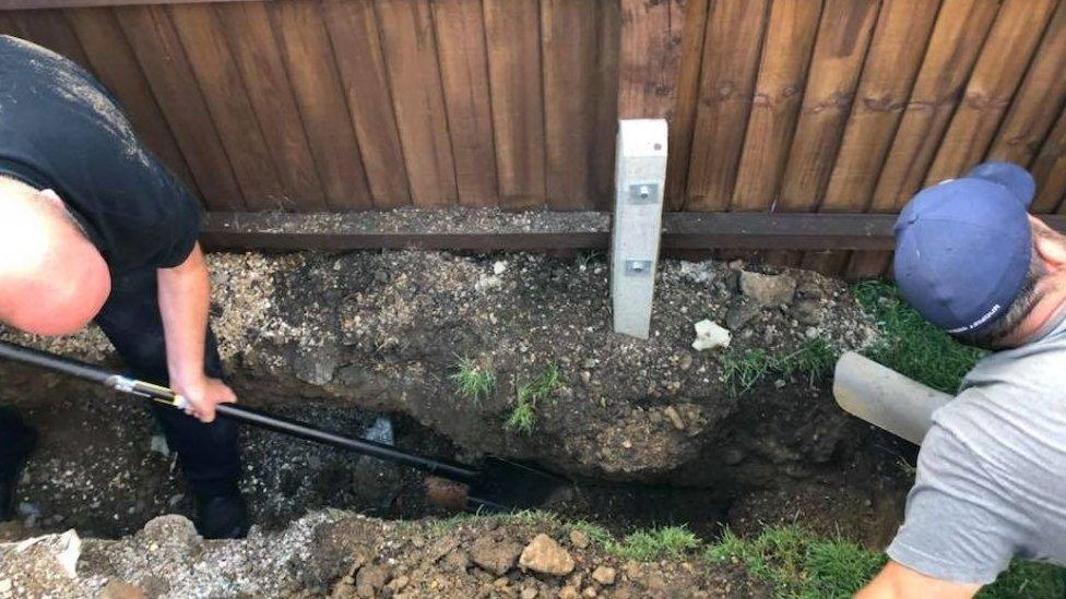 RSPCA officer and man digging hole