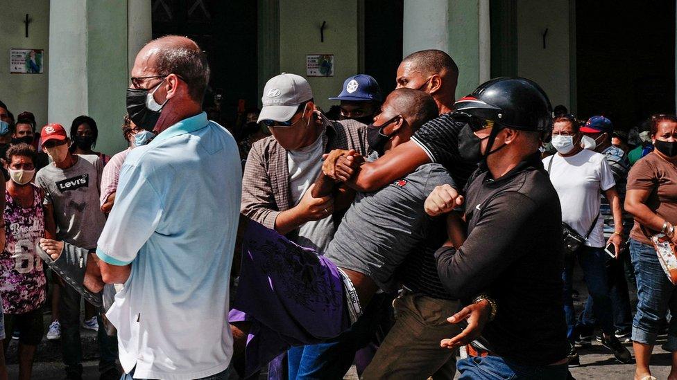 A man is arrested during a demonstration against the government of Cuban President Miguel Diaz-Canel in Havana