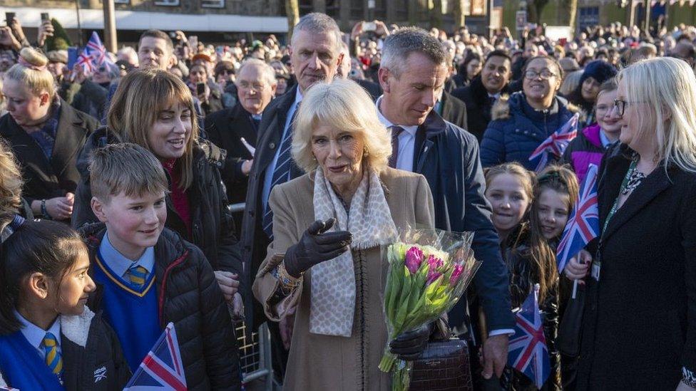 The Queen Consort meeting members of the public during a visit to Bolton Town Hal