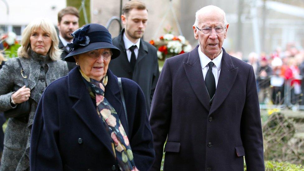 Sir Bobby Charlton and wife arriving at the funeral service for Gordon Banks at Stoke Minster