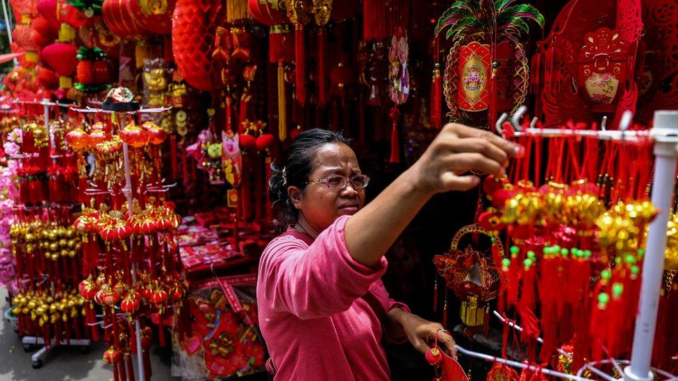 A woman at a shop selling Lunar New Year decorations in Jakarta, Indonesia