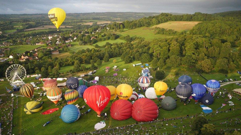 Hot air balloons are inflated during the mass ascent at the Bristol International Balloon Fiesta 2023.