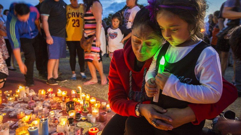 Mourners attend a vigil for four people who died at Australia's Dreamworld theme park