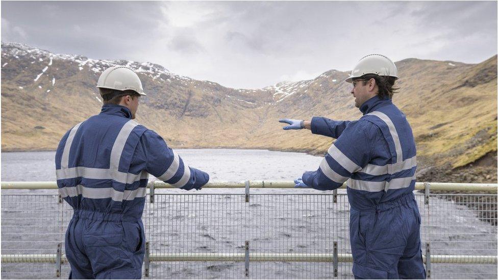 Two workers on a dam