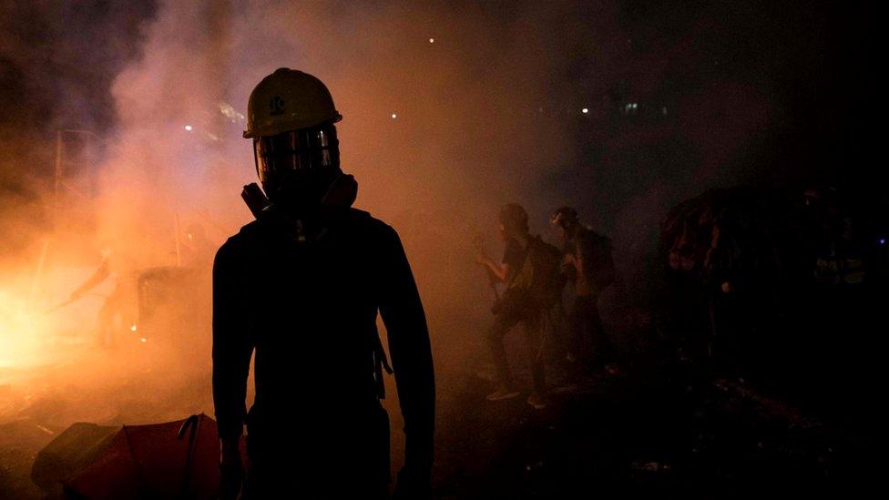 Protester in front of fire