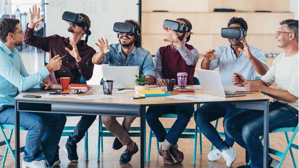 A group of workers wearing VR goggles