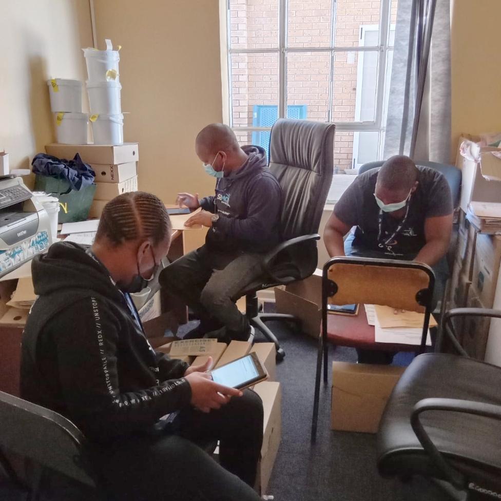 Volunteers examining reports