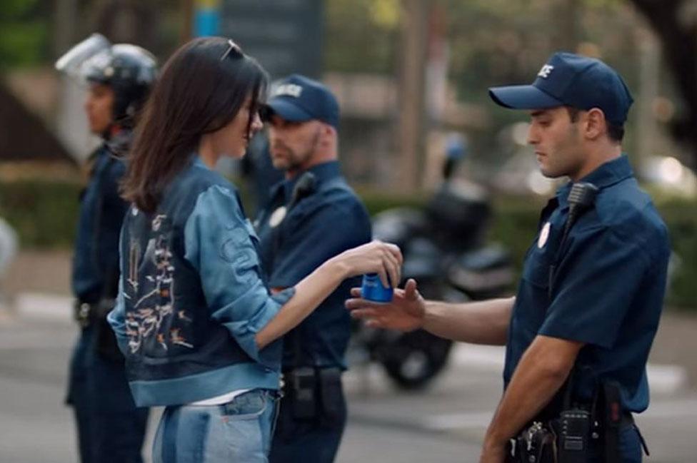 Kendall Jenner gives drink to officer